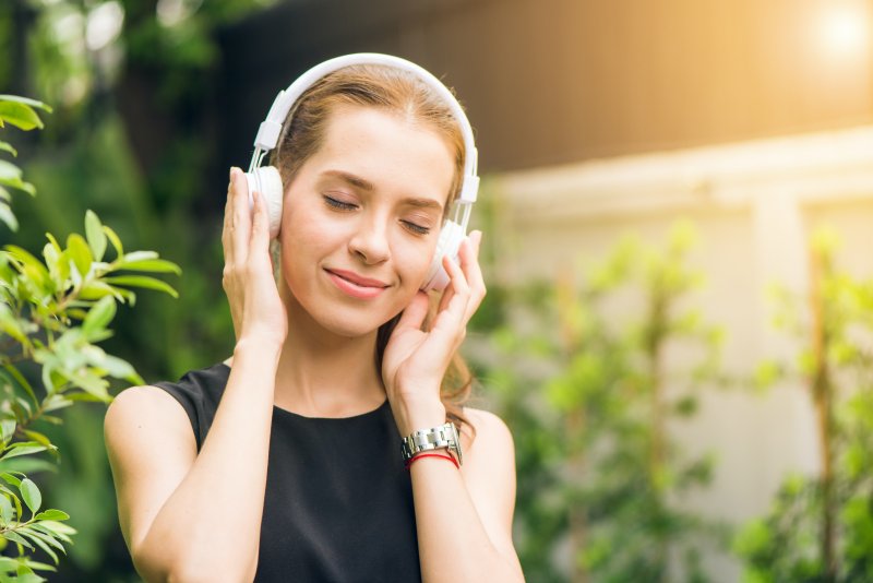 Woman smiling and listening to relaxing music