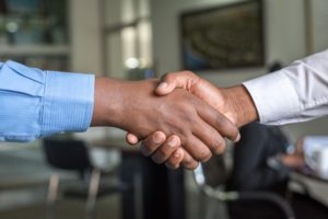 Two businessmen shaking hands to finalize agreement